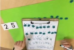 A clipboard with a number and a hand pointing at it
Description automatically generated